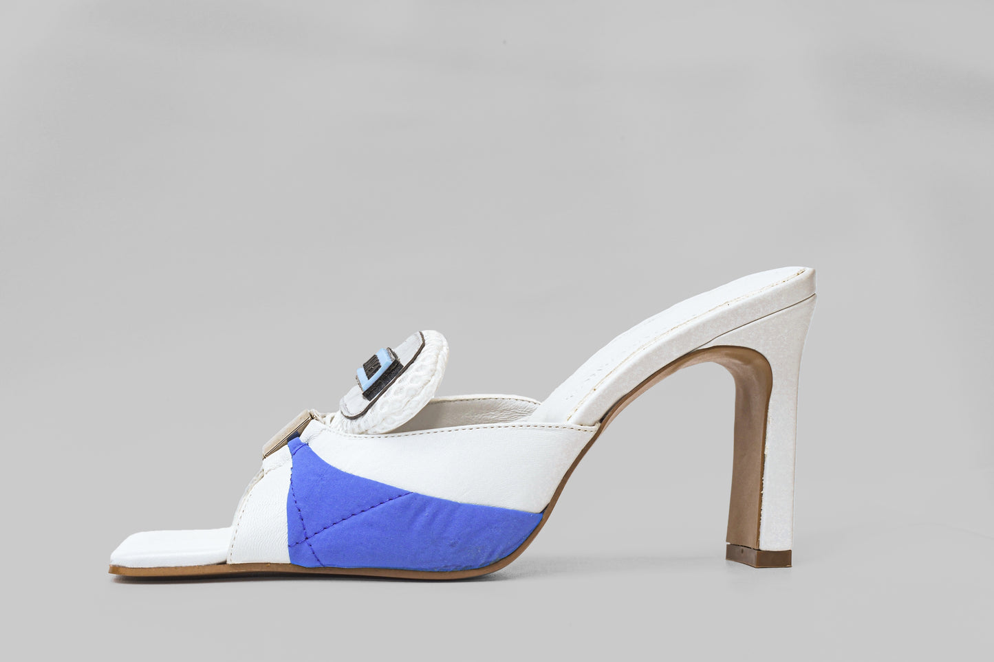A photo of the side view of Ancuta Sarca Lithium Sandal, white and blue with 9CM HEEL, PANELLED DESIGN, SQUARE TOE, PADDED MESH TONGUE WITH LOGO PATCH, SILVER TONE HARDWARE, MADE IN ITALY