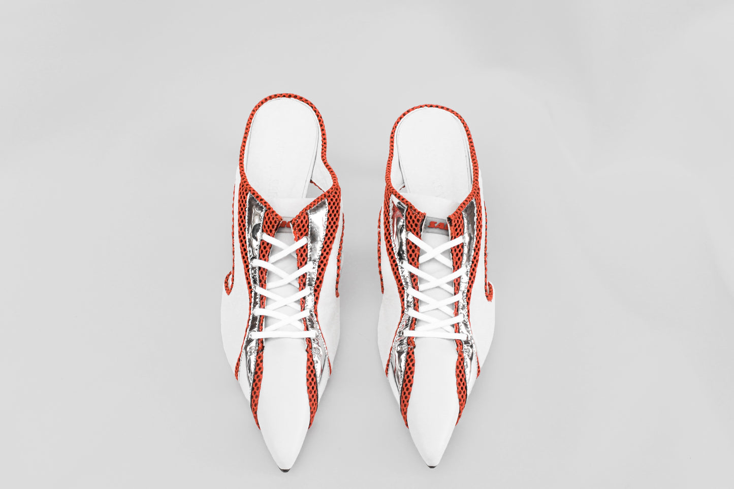 A photograph of the top view of a pair of Ancuta Sarca Moto' Mule White shoes, 5CM SCULPTED HEEL, SLIP-ON STYLE, PANELLED DESIGN, FAUX LACE-UP FASTENING, LOGO PATCH MESH TONGUE, BRANDED FOOTBED POINTED TOE, MADE IN ITALY