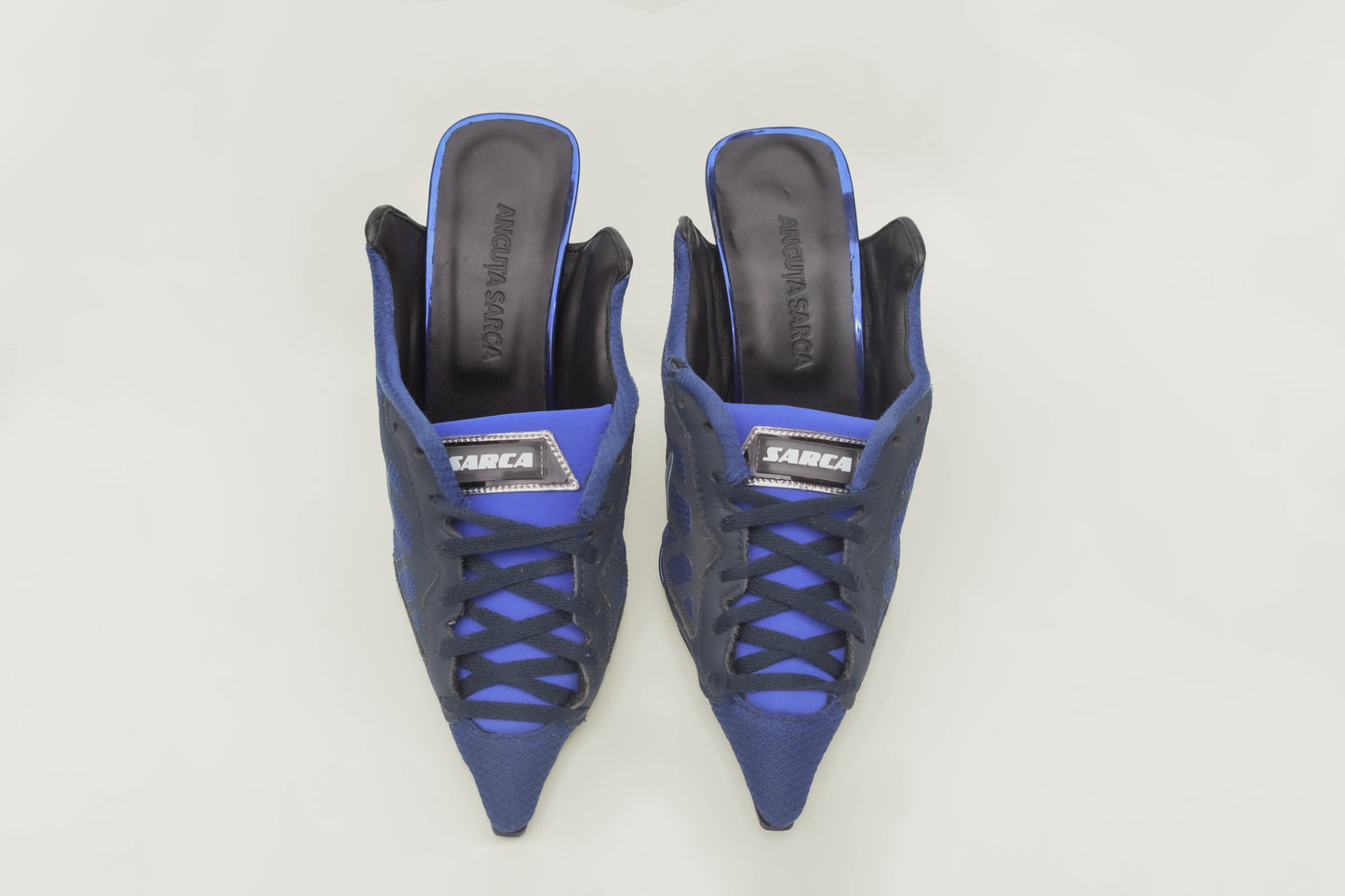 A photograph of the top view of a pair of Ancuta Sarca Olympia Heel Blue Shoes, WITH BLACK AND LIGHT BLUE DETAILS, FRONT LACE-UP FASTENING, POINTED TOE, SLIP-ON STYLE, MADE IN ITALY