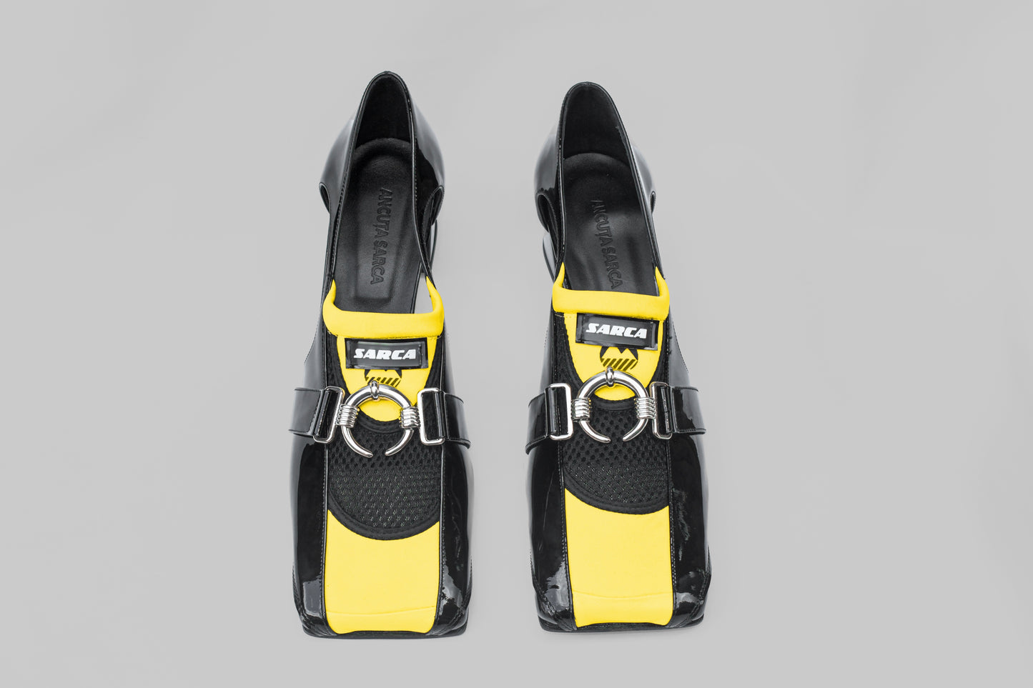 A photograph of the top view of a pair of Ancuta Sarca Olga Loafers in black, 4.5CM HEEL, PANELLED DESIGN, SQUARE TOE, CUTOUT AT SIDES, SILVER TONE HARDWARE, MADE IN ITALY