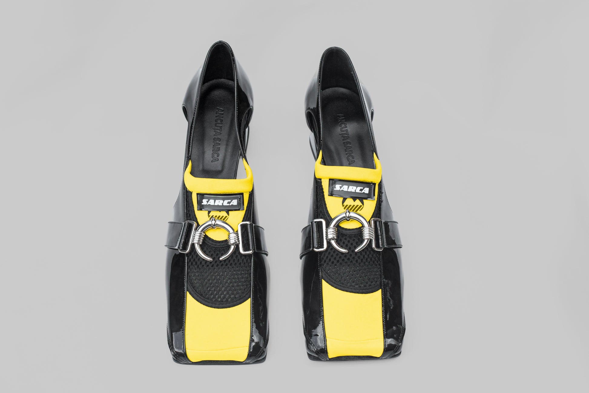 A photograph of the top view of a pair of Ancuta Sarca Olga Loafers in black, 4.5CM HEEL, PANELLED DESIGN, SQUARE TOE, CUTOUT AT SIDES, SILVER TONE HARDWARE, MADE IN ITALY