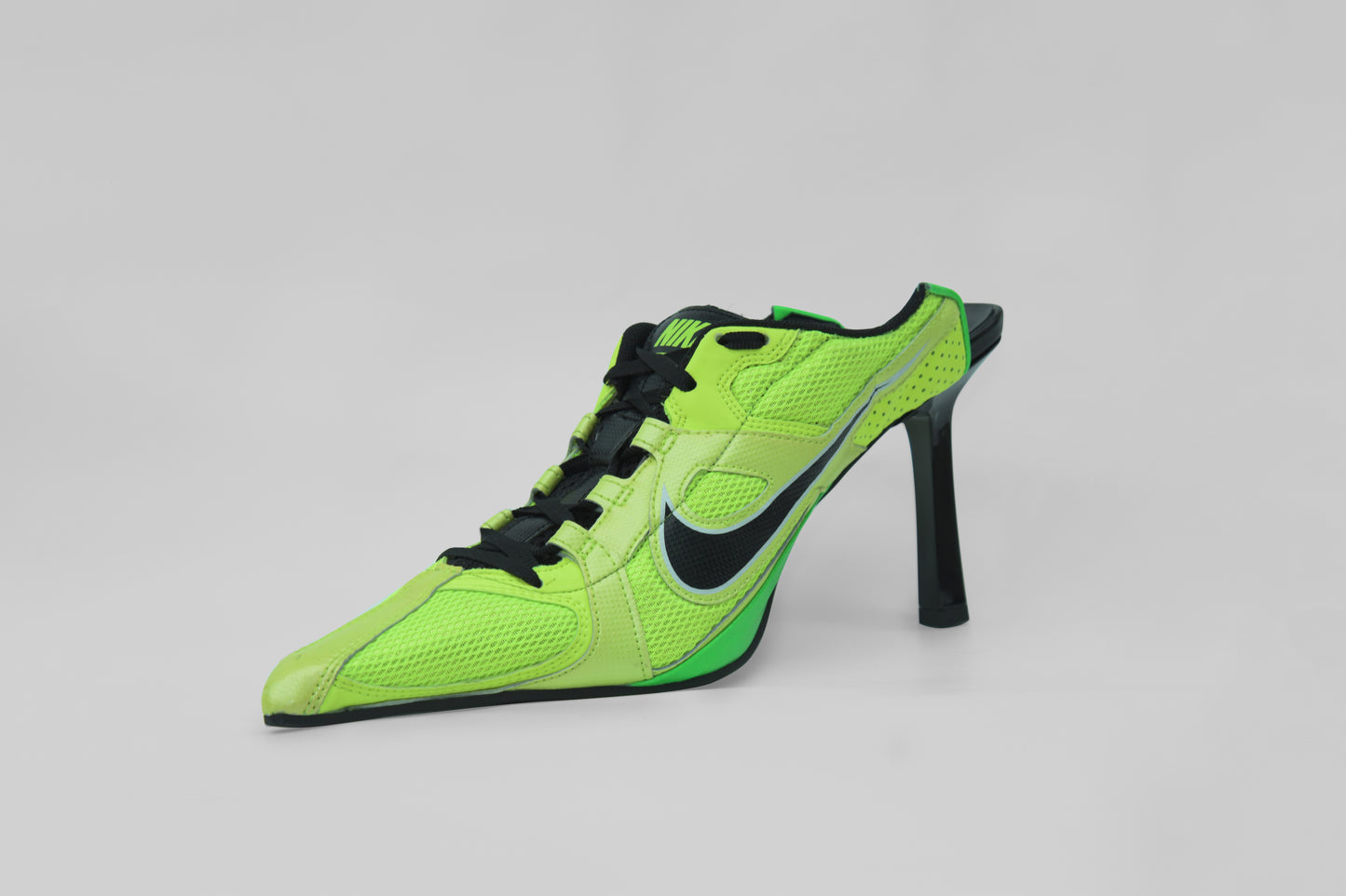 A photograph of the diagonal view of Ancuta Sarca Olympia Heel Green Shoe, GREEN AND BLACK, FRONT LACE-UP FASTENING, POINTED TOE, SLIP-ON STYLE, MADE IN ITALY