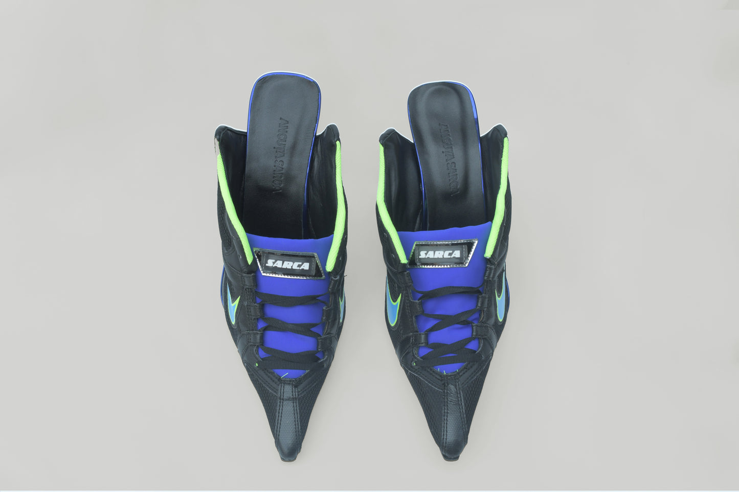 A photograph of the top view of a pair of Ancuta Sarca Olympia Heel Black shoes, WITH BLUE AND GREEN DETAILS, FRONT LACE-UP FASTENING, POINTED TOE, SLIP-ON STYLE, MADE IN ITALY