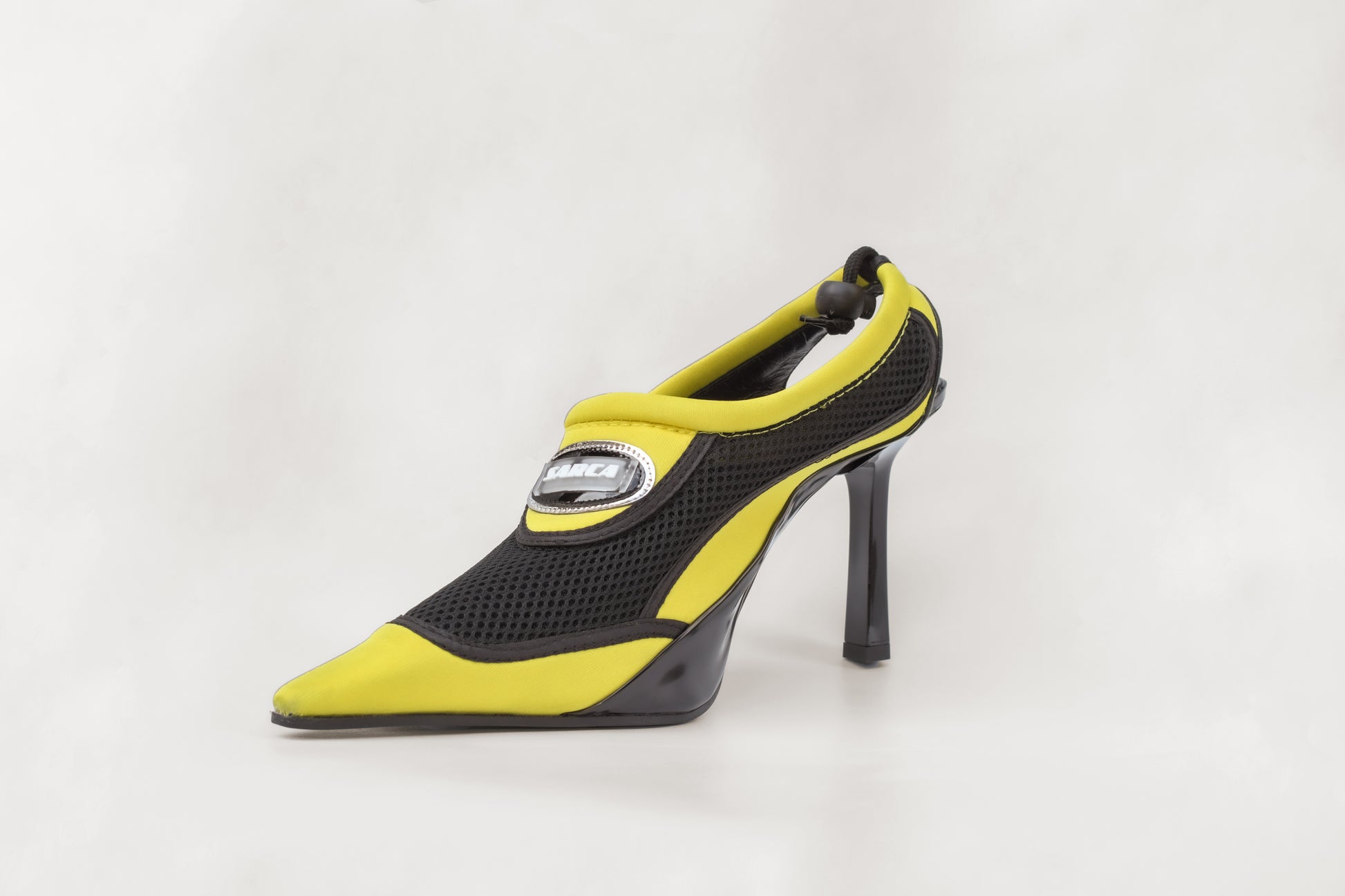 A photograph of the diagonal view of Ancuta Sarca Aqua Heel Black and Yellow shoe, 10CM HEEL, SLIP-ON STYLE, PANELLED DESIGN, TOGGLE BACK FASTENING, MADE IN ITALY