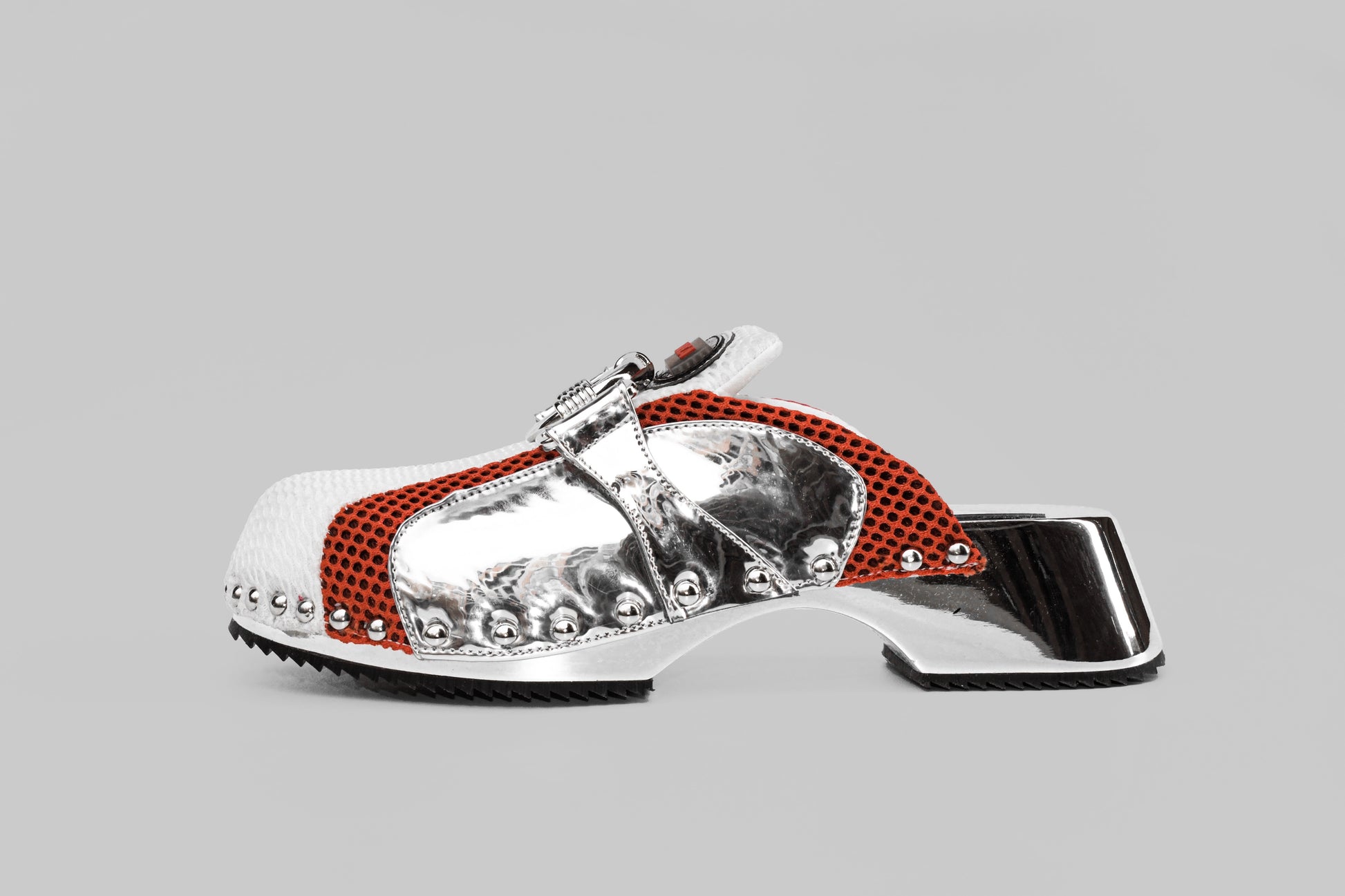 A photograph of the side view of Ancuta Sarca Beetle Clog Mirror, MIRROR FINISH, MESH PANEL WITH RING EMBELLISHMENT, LOGO PATCH AT TONGUES, BRANDED FOOTBEDS, ROUND TOES, SILVER TONE HARDWARE, MADE IN ITALY