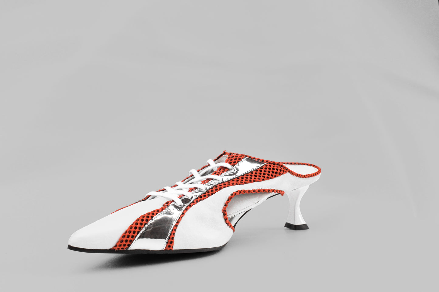 A photograph of the diagonal view of Ancuta Sarca Moto' Mule White, 5CM SCULPTED HEEL, SLIP-ON STYLE, PANELLED DESIGN, FAUX LACE-UP FASTENING, LOGO PATCH MESH TONGUE, BRANDED FOOTBED POINTED TOE, MADE IN ITALY