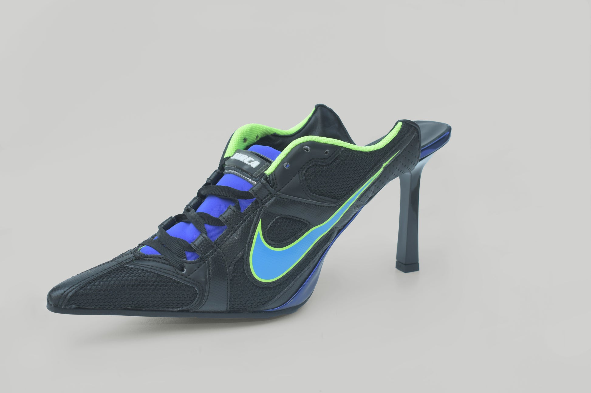 A photograph of the diagonal view of Ancuta Sarca Olympia Heel Black shoe, WITH BLUE AND GREEN DETAILS, FRONT LACE-UP FASTENING, POINTED TOE, SLIP-ON STYLE, MADE IN ITALY